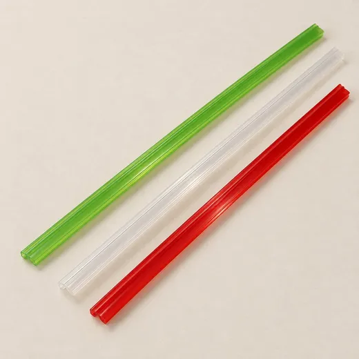 Universal zipper profiles in red, natural and green laid side by side.