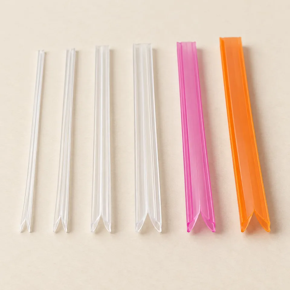 Press to close zipper profile samples in 3 mm, 10 mm and 12 mm, in natural, pink and orange.